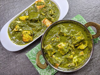 A bowl of Palak Paneer made of Paneer cheese dipped in mildly spiced Spinach gravy.