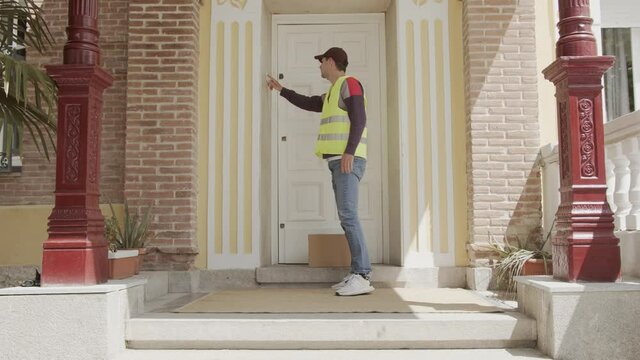 delivery man delivers the parcel at home