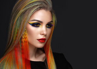 Beautiful girl with multi-colored hair and creative make-up and hairstyle. Beauty face.