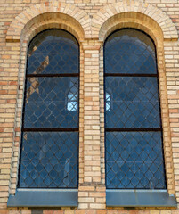 Old vintage window on a brick building. Arched windows on the church.