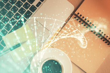 DNA hologram drawings over computer on the desktop background. Top view. Multi exposure. Concept...