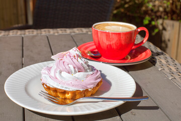 Coffee and cake on the table of an outdoor cafe