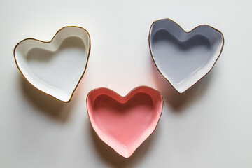 Three plates of hearts on a white background in blue, red and white.