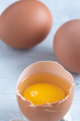 Chicken eggs broken in the middle of other eggs. Top view