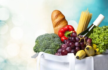 Full shopping bag with vegetable on bokeh background