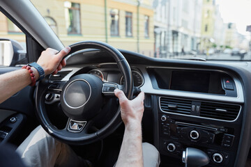 Professional young driver holding steering wheel with both hands