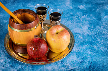 On the table in the synagogue are the symbols of Rosh Hashanah apple and pomegranate