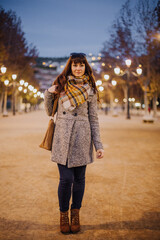 Girl walking through the city in autumn