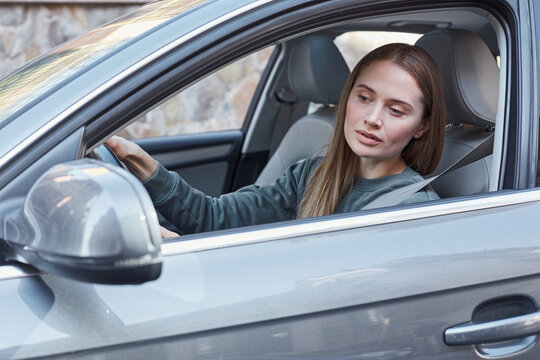 Concentrated female driver carefully watching the road