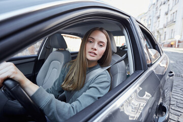 Lovely young female driver watching the road