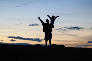 Daddy daughter moment, cheering on a sunset