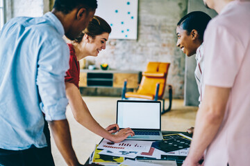 Obraz premium Multiethnic content students studying together on laptop at classroom