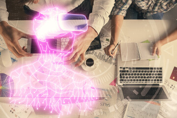 Double exposure of man and woman working together and man in virtual glasses hologram drawing. Computer background. Top View. VR, AR concept.