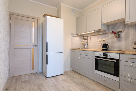 The interior of a small cozy kitchen in the apartment, the interior door to the kitchen is closed