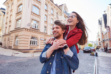 Mirthful young couple enjoying leisure time outdoors