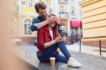 Joyous young couple feeling amused with each other