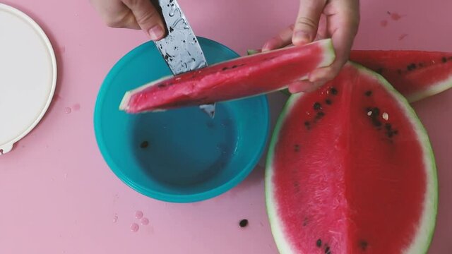 cutting the watermelon into the storage container