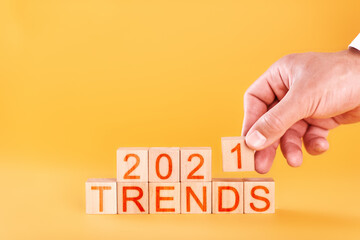 trends 2021. male hand builds an inscription from wooden blocks