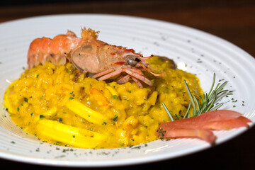 seafood risotto with shrimp on wooden table