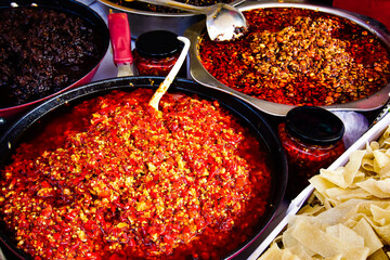 Red spicy pepper sauce in market stall