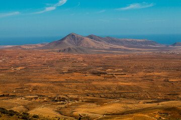 Fototapeta na wymiar Landscape of Panoramic vulcanic mountains and Atlantic Ocean , dunes of coralejo and Gran Tarajal Port in Fuerteventura, Lanzarote 