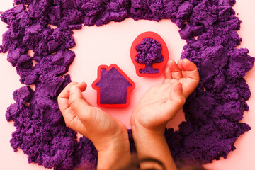 hands little kid mold house and tree, playing with kinetic sand. the development of fine motor...