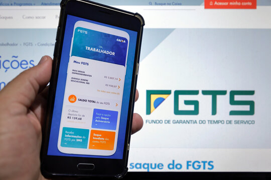 computer screen and cell screen with Caixa bank FGTS application