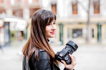 Female photographer taking photos in the city