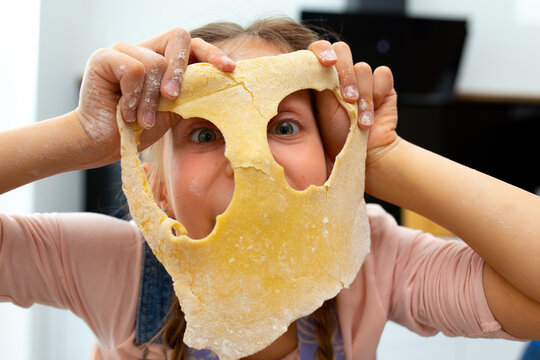 Adorable Girl Covering Face With Mask Of Dough