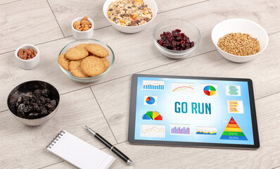Organic food and tablet pc showing GO RUN inscription, healthy nutrition composition