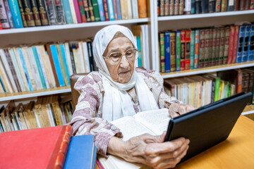 Arabic muslim woman using laptop for reading E-books nad surfing internet