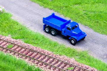 Blue scale truck on model train railroad layout road