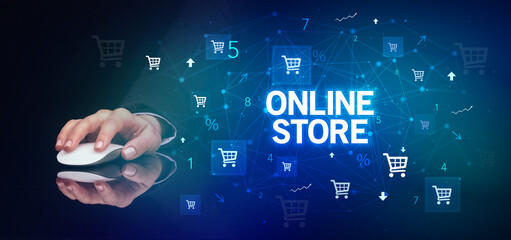 hand holding wireless peripheral with ONLINE STORE inscription, online shopping concept