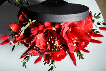 top view on elegant bouquet made from red lilies, roses, and fresh greenery