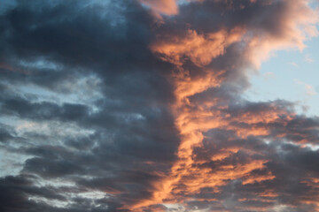 Fototapeta na wymiar Blue, Gray, and Orange Clouds at Sunset