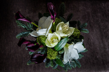 top view on elegant bouquet made from white lily, purple calla, and fresh greenery
