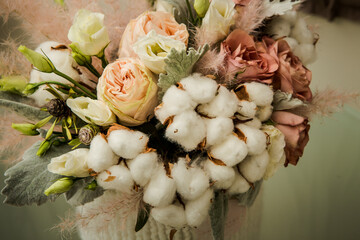 top view on exquisite bouquet of white cotton flowers and assorted roses