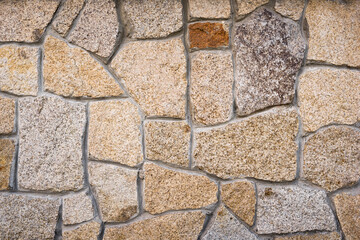 Texture of the external part of the masonry wall. Architecture of a decorated wall.