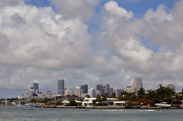 View of jet ski boats racing on Biscayne Bay and the downtown Miami tall building skyline.
