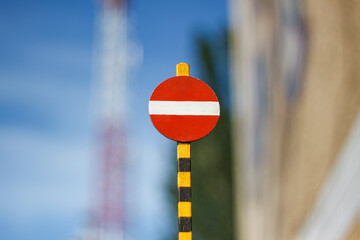 A small traffic sign prohibiting travel and entering the location is  isolated on the blue blurred...