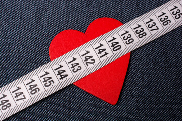 Heart shape and measuring tape. Valentine concept and promise of love.