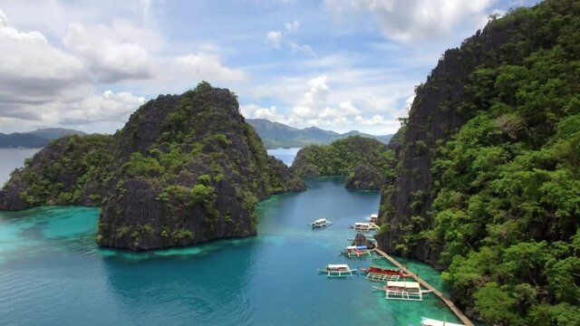 Aerial view of outrigger boats and karst scenery at Kayangan Lake in Coron island, Palawan, Philippines.
