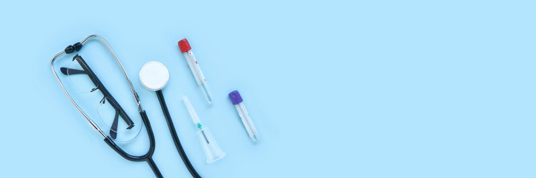stethoscope and eyeglass lying on a blue background. The concept of medical equipment instrument.