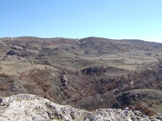 Former fortress on a hilltop stretching toward mountain in rural area