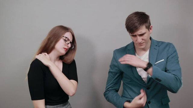 Holds the shoulder hurts, pain in my arm, sore point, problem with health care and exercise. Feel hurt. Terrible ache in spine. Exercises for back. Attractive couple boyfriend girlfriend two people
