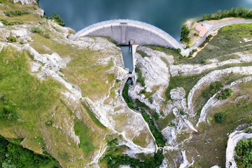 Aerial drone footage Water dam and reservoir lake, generating hydro electricity power renewable...