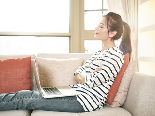 young asian woman working at home