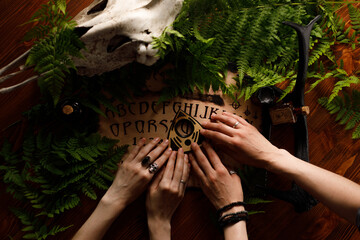 Mystic ritual with Ouija and candles. Devil's board concept, black magic or fortune telling rite...