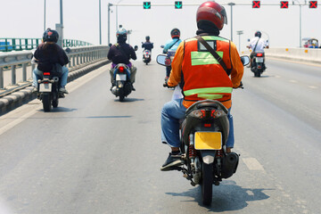 Man ride on motorcycle going upward the bridge