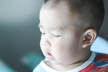An Asian baby is wondering in the morning sunshine - Focus piont and Light fair concept.